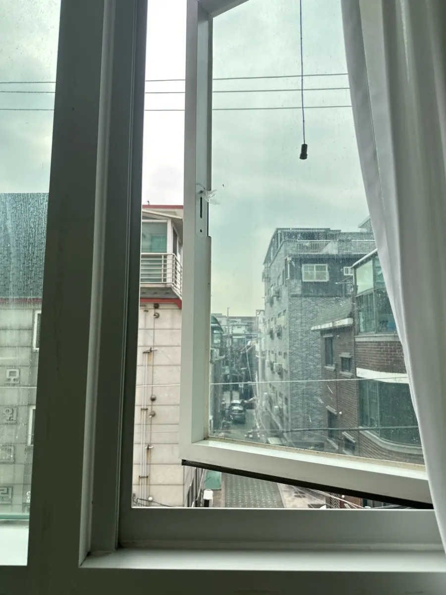 창문 손잡이와 창틀 사이 링크 부품을 살펴보는 모습
